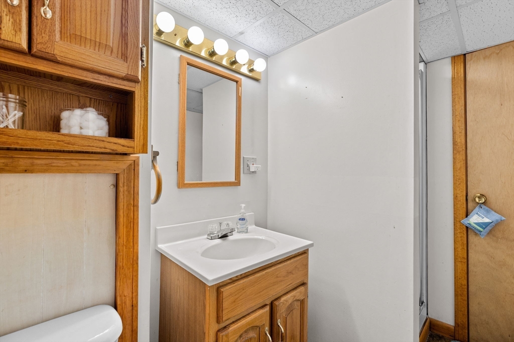 39 High Street Freetown, MA 02702 - Photo 28 of 42 a bathroom with a sink a toilet and mirror