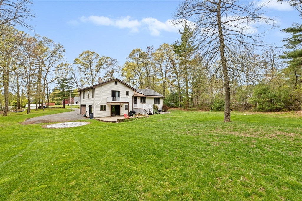 39 High Street Freetown, MA 02702 - Photo 36 of 42 a view of a white house in front of a big yard with large trees