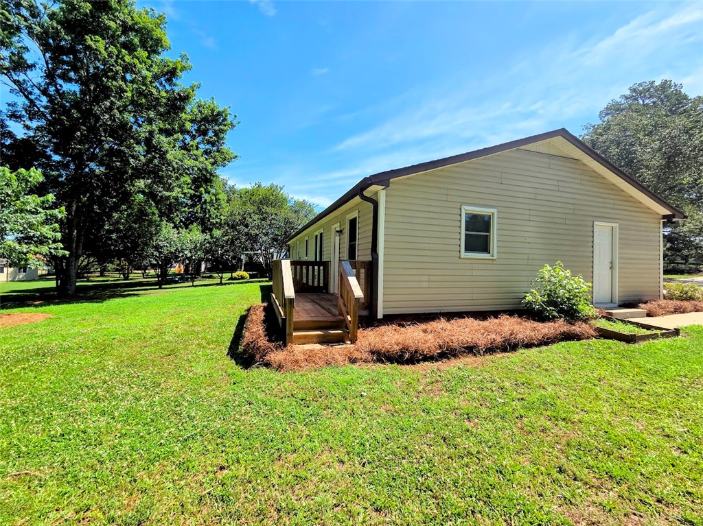 509 Elrod Road Piedmont, SC 29673 - Photo 25 of 28 A modest side entry leads to this home, nestled among mature trees and a verdant lawn.