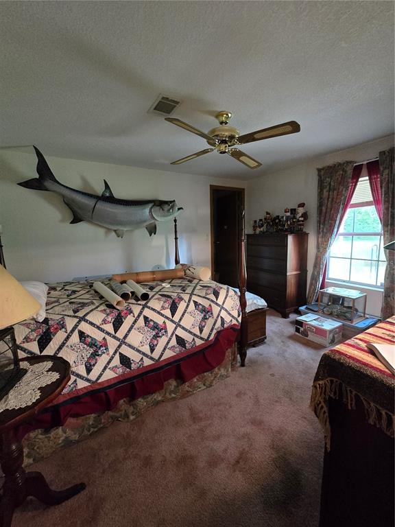 4901 Northwest 152nd Lane Reddick, FL 32686 - Photo 13 of 13 a bedroom with a bed and a chandelier