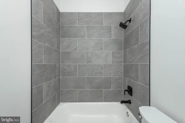 a bathroom with a bathtub and toilet