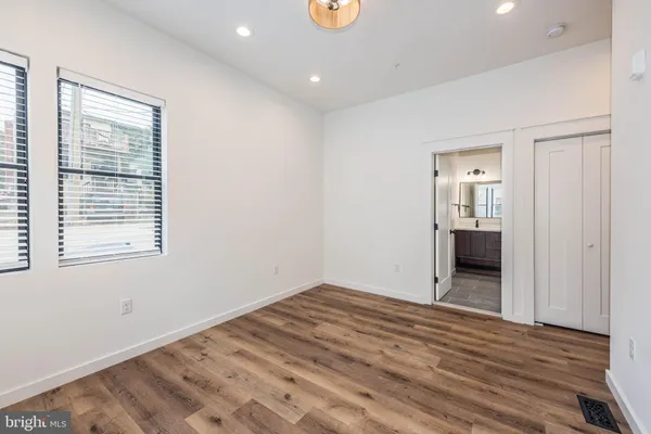 a view of a room with wooden floor and window