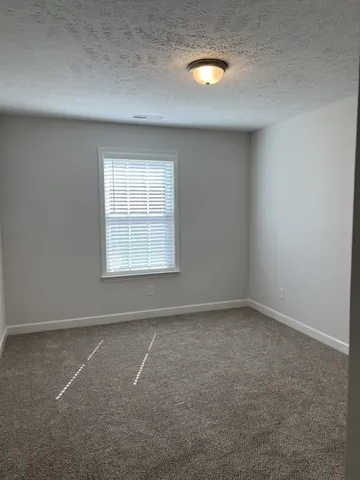 an empty room with a empty space and windows