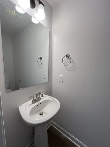 a bathroom with a sink and mirror