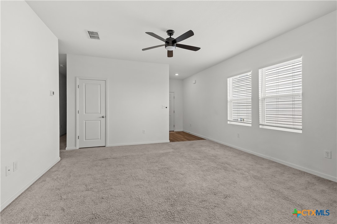 430 Line Of Fire Way Jarrell, TX 76537 - Photo 12 of 28 a view of an empty room with a ceiling fan