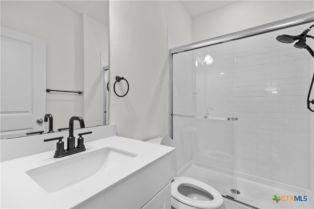 430 Line Of Fire Way Jarrell, TX 76537 - Photo 13 of 28 a bathroom with a sink and a mirror