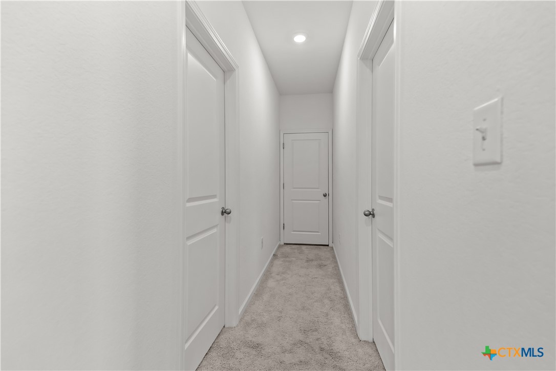 430 Line Of Fire Way Jarrell, TX 76537 - Photo 16 of 28 a view of a hallway with a white door