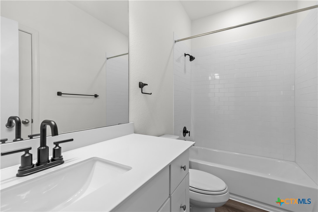 430 Line Of Fire Way Jarrell, TX 76537 - Photo 18 of 28 a bathroom with a sink a toilet and a bathtub