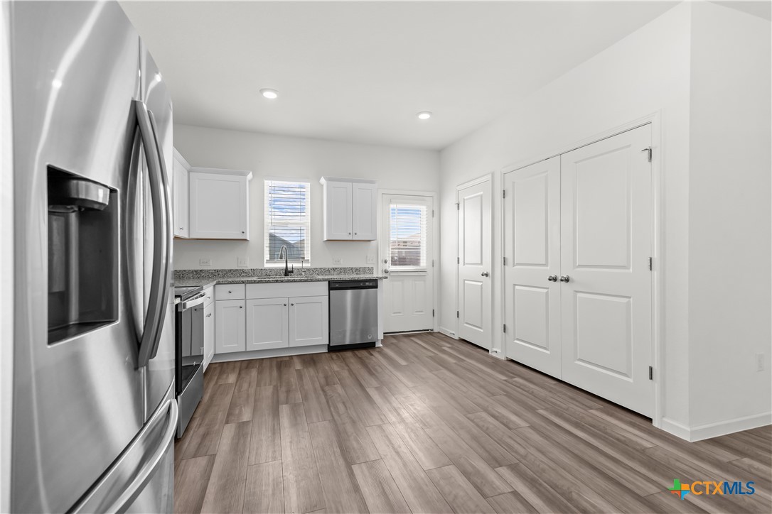 430 Line Of Fire Way Jarrell, TX 76537 - Photo 10 of 28 a large kitchen with a lot of counter space stainless steel appliances and cabinets