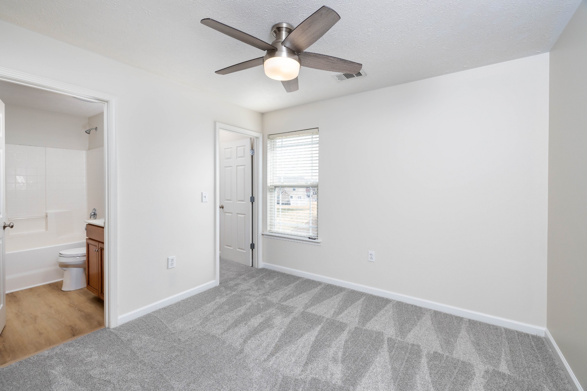 1011 Somerset Springs Drive Spring Hill, TN 37174 - Photo 22 of 28 a view of a big room with windows and a chandelier fan