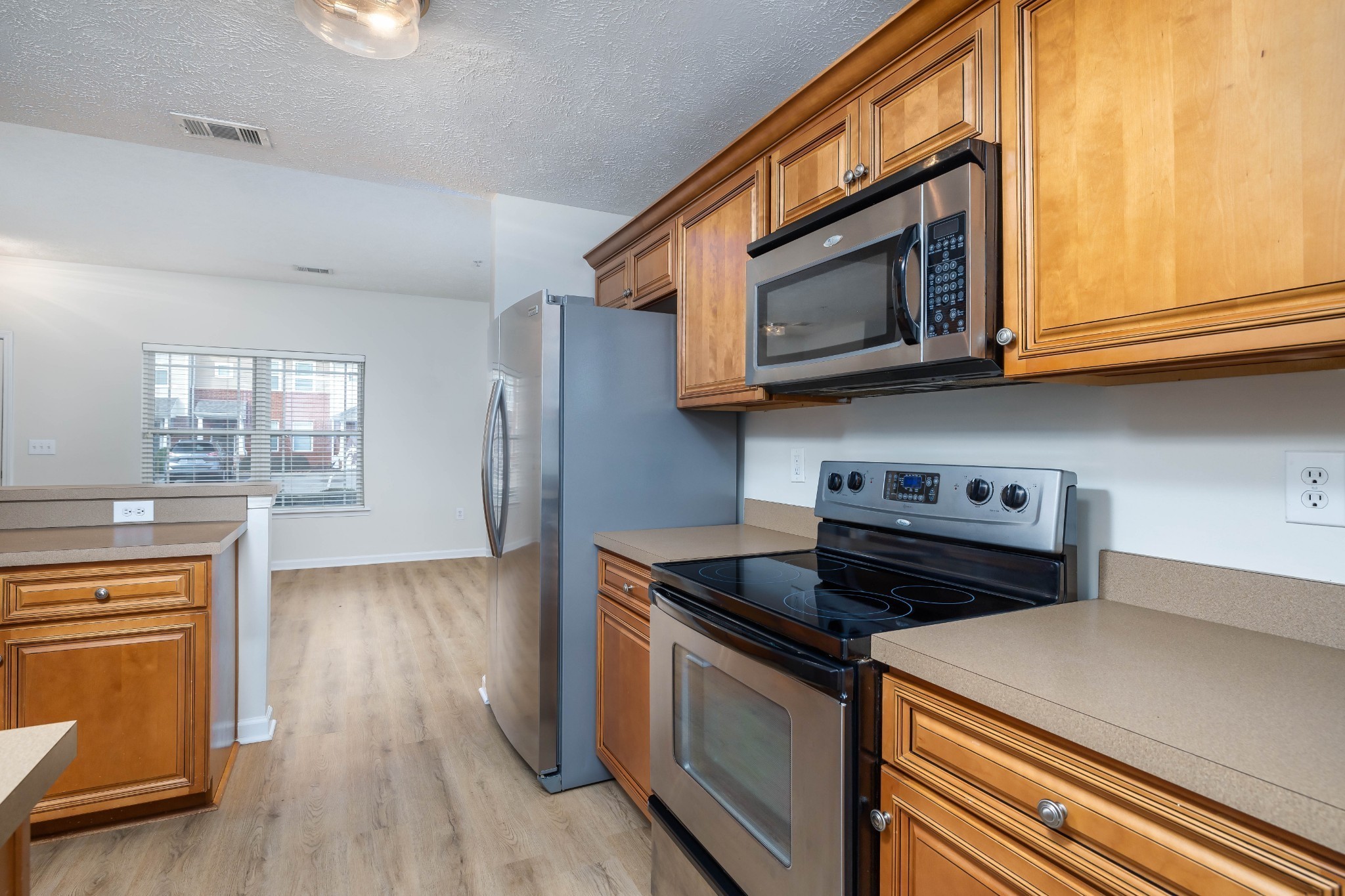 1011 Somerset Springs Drive Spring Hill, TN 37174 - Photo 10 of 28 a kitchen with stainless steel appliances granite countertop a stove and a microwave
