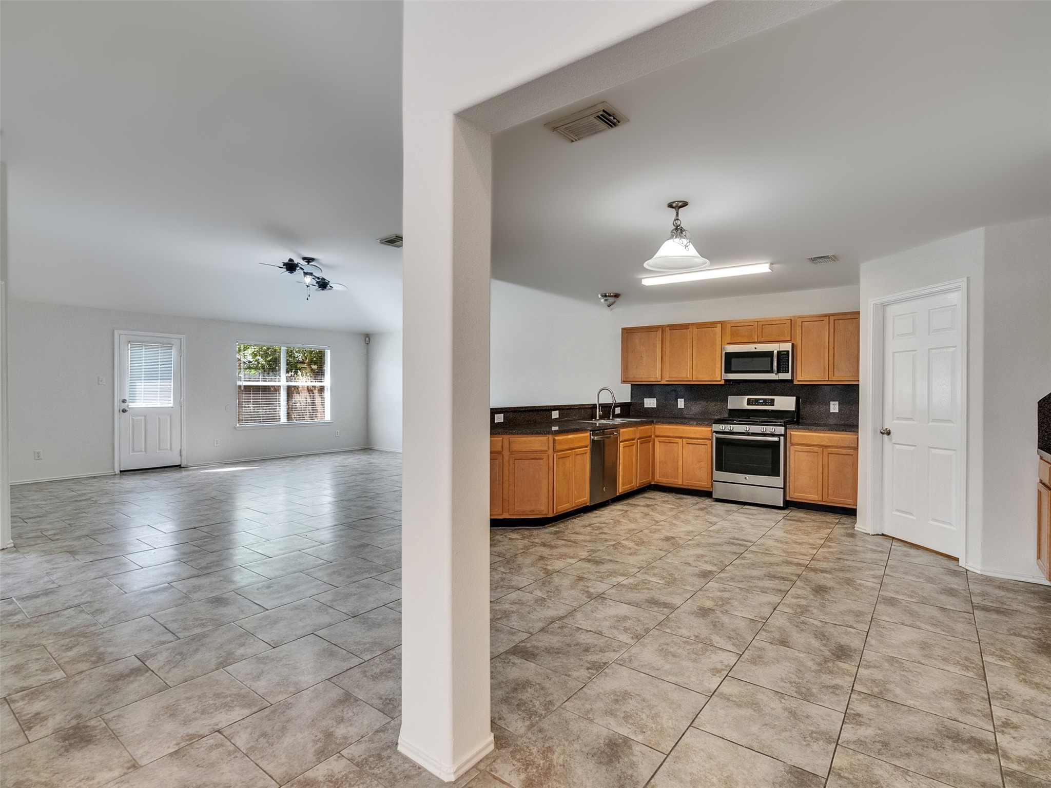 13431 Rural Oak Street Houston, TX 77034 - Photo 5 of 24 a view of kitchen with kitchen island granite countertop a stove top oven a sink a counter space and cabinets