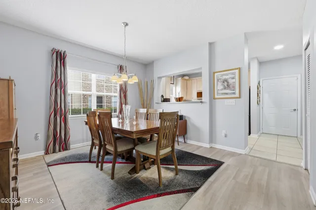 a view of a dining room with furniture and window