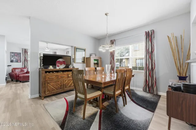 a kitchen with stainless steel appliances granite countertop a refrigerator a sink dishwasher a stove with white cabinets and wooden floor