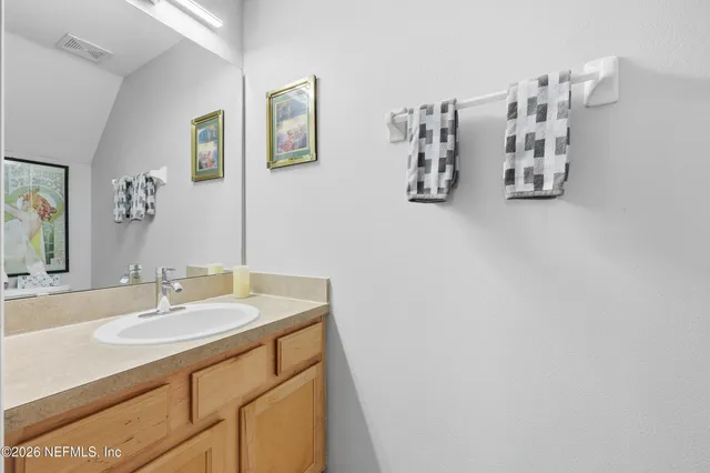 a view of a hallway with wooden floor and furniture
