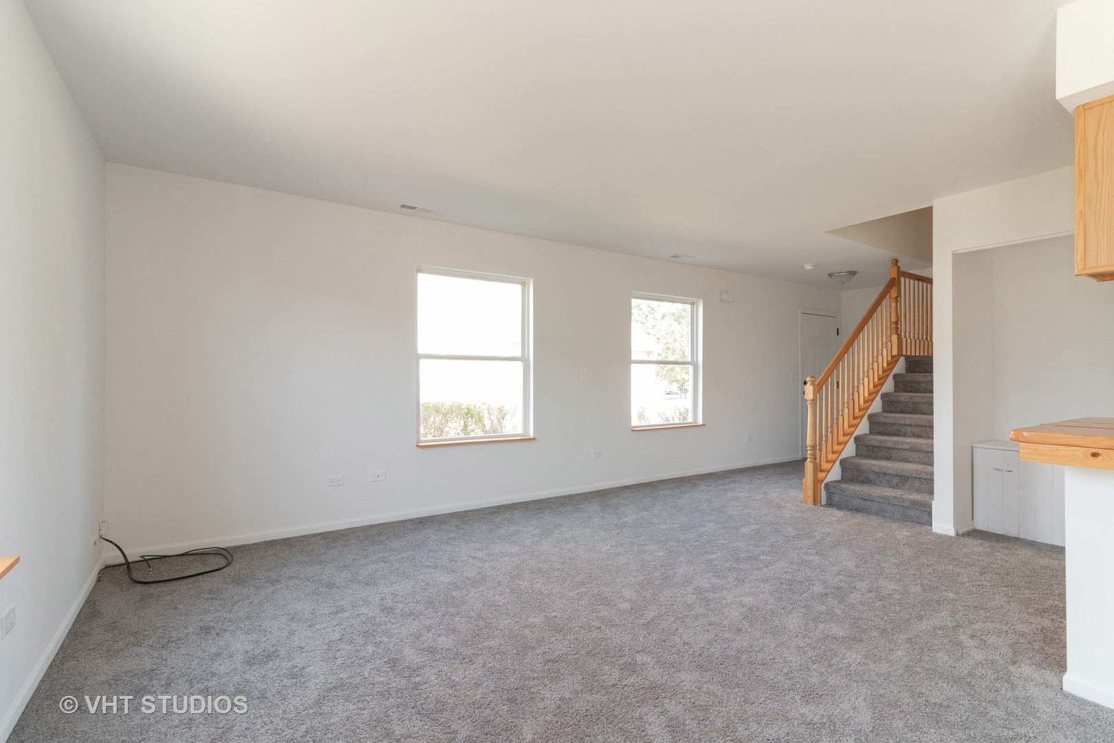 25188 Faraday Road Manhattan, IL 60442 - Photo 4 of 10 an empty room with stairs and windows