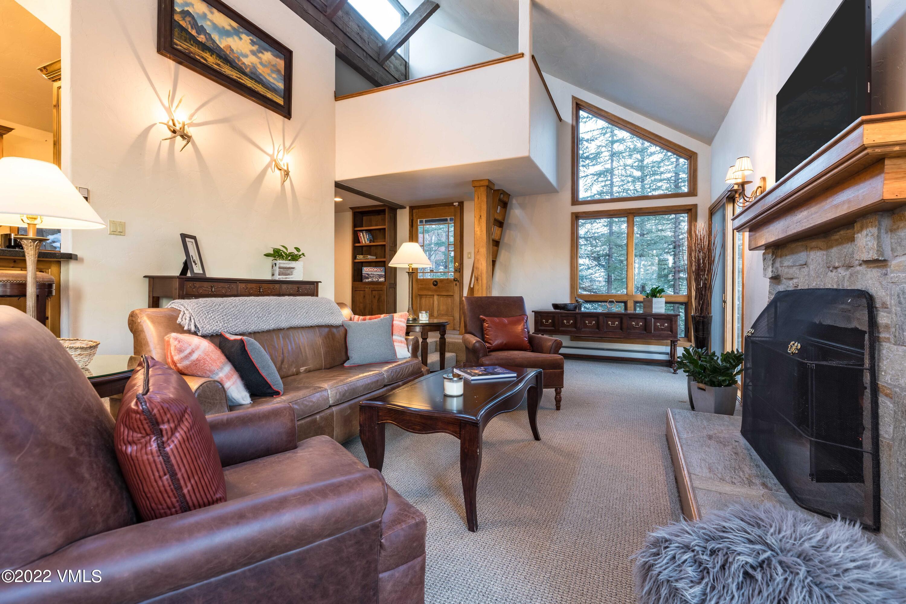 224 West Forest Road Vail, CO 81657 - Photo 2 of 12 a living room with furniture and a fireplace