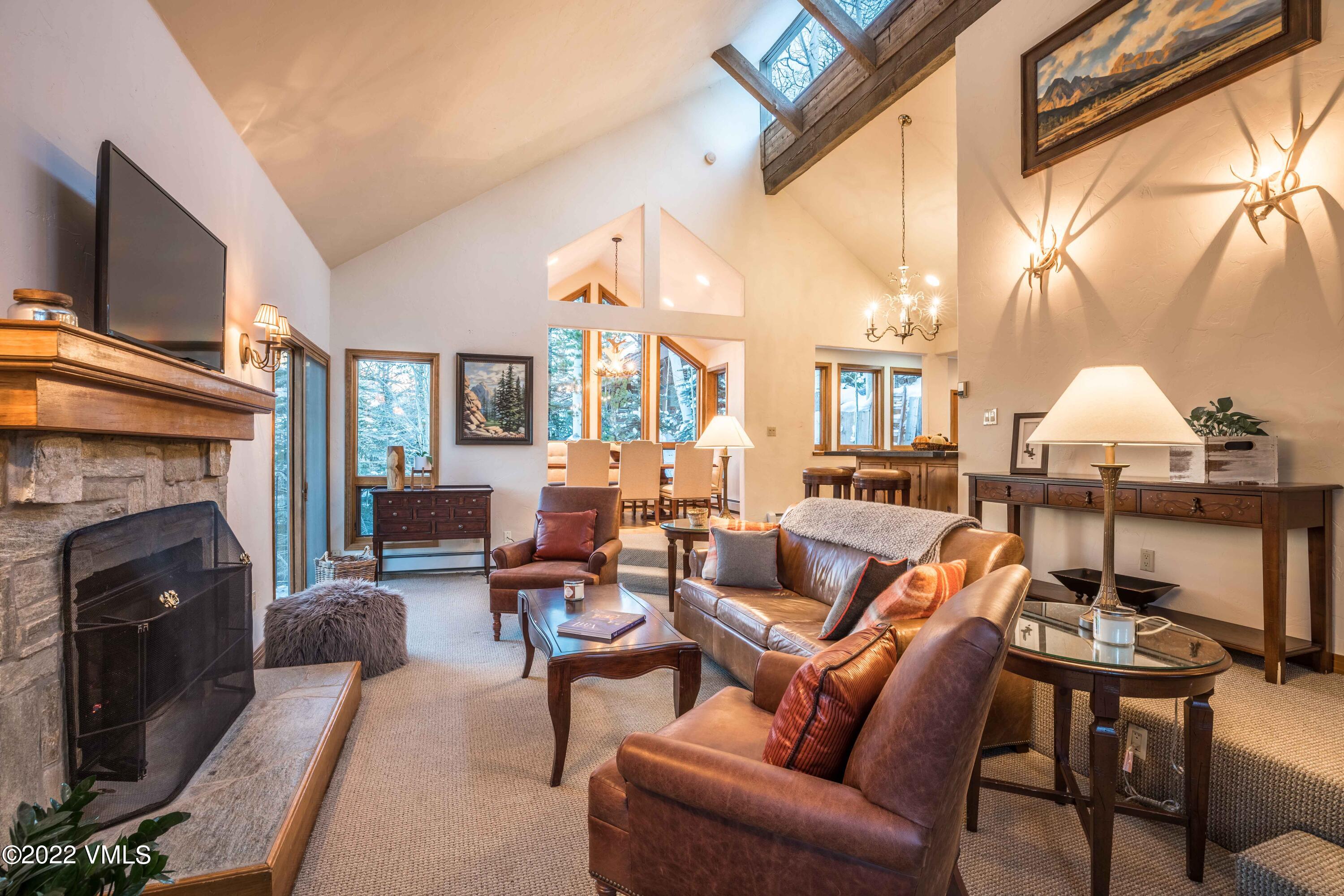 224 West Forest Road Vail, CO 81657 - Photo 3 of 12 a living room with furniture a fireplace and a flat screen tv