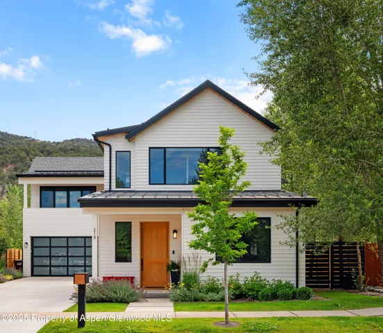 a house that has a tree in front of it
