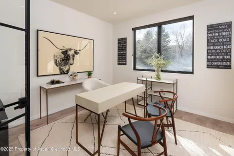 a view of a dining room with furniture large window and outside view
