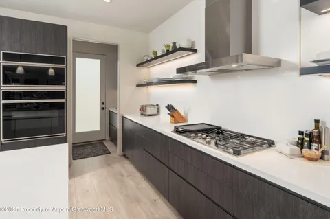a kitchen with stainless steel appliances a stove and a refrigerator