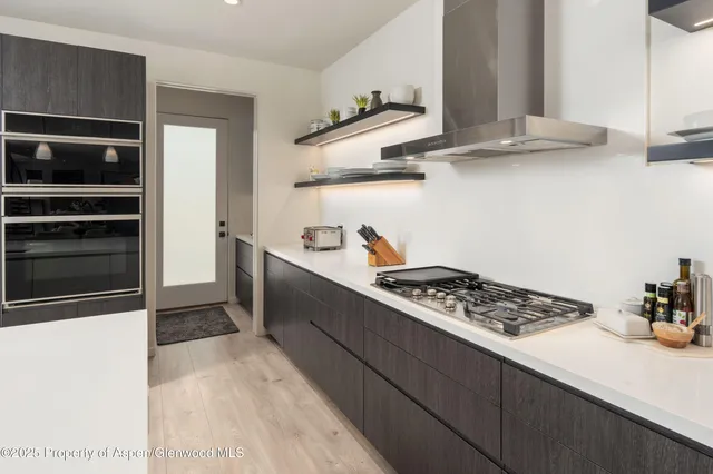 a kitchen with stainless steel appliances a stove and a refrigerator