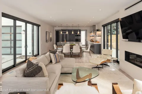 a living room with furniture fireplace and flat screen tv