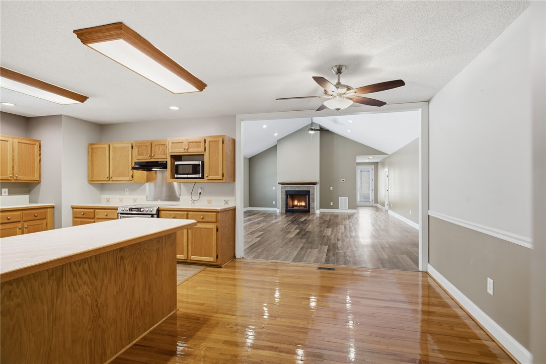 196 Flyroot Trail Pickens, SC 29671 - Photo 11 of 48 This spacious kitchen and living area feature vaulted ceilings, hardwood floors, and a charming fireplace.