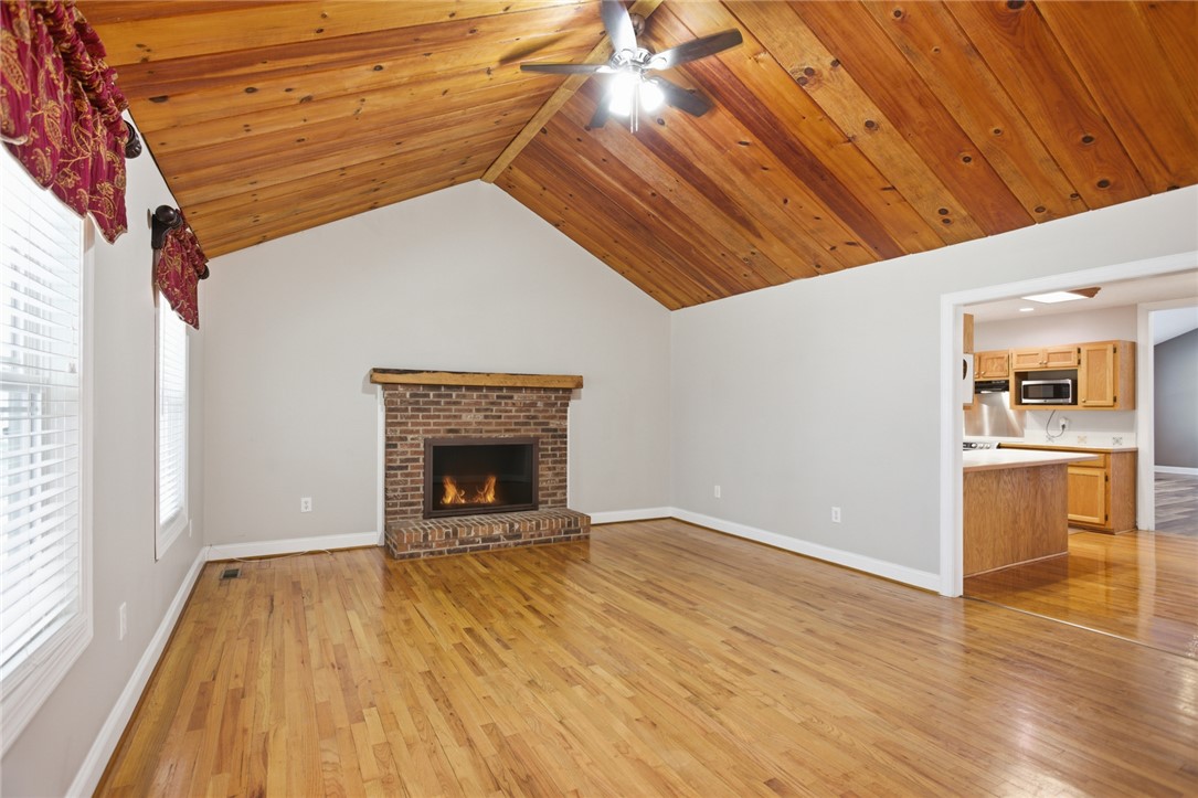 196 Flyroot Trail Pickens, SC 29671 - Photo 15 of 48 This inviting living area boasts a warm fireplace and charming wood vaulted ceilings.