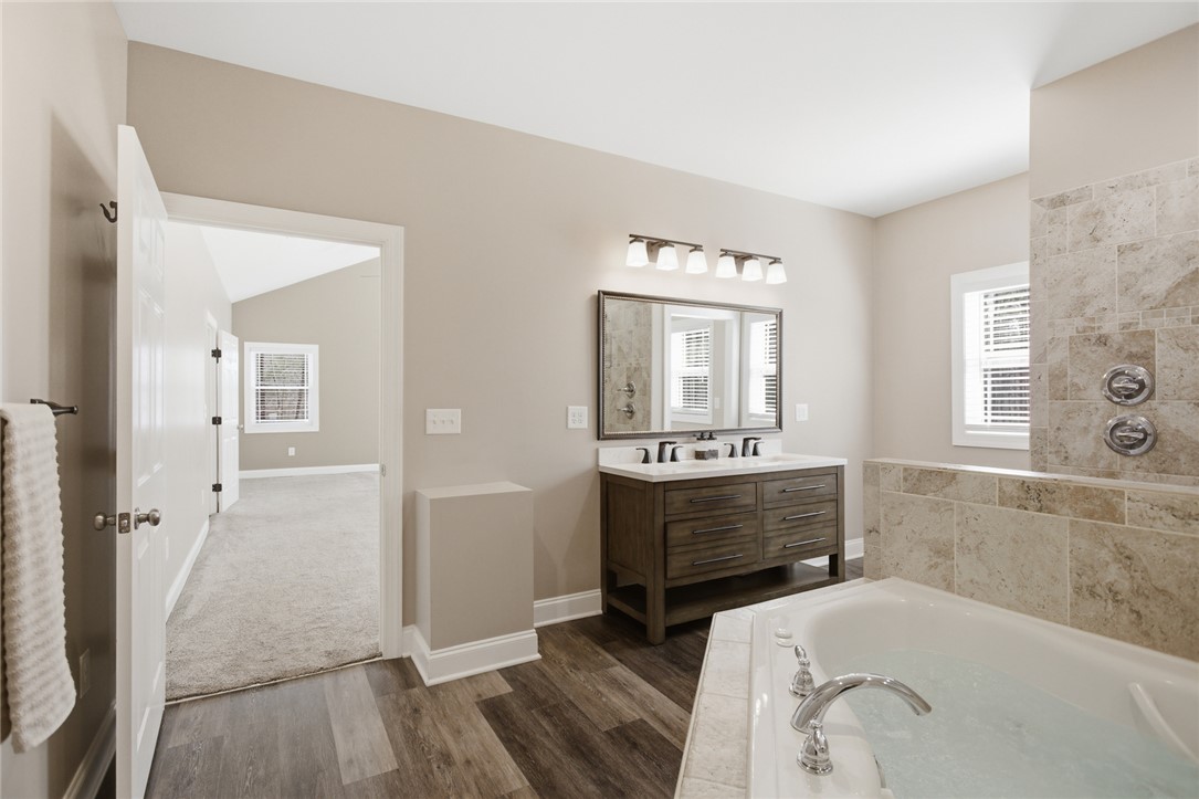 196 Flyroot Trail Pickens, SC 29671 - Photo 20 of 48 This serene bathroom offers a tranquil retreat with elegant finishes and a relaxing soaking tub.