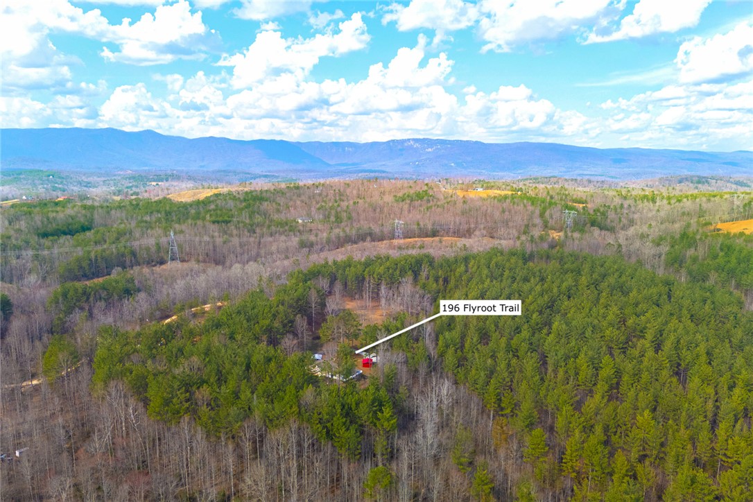 196 Flyroot Trail Pickens, SC 29671 - Photo 2 of 48 This elevated view captures the extensive, wooded property nestled amidst rolling hills and distant mountains.