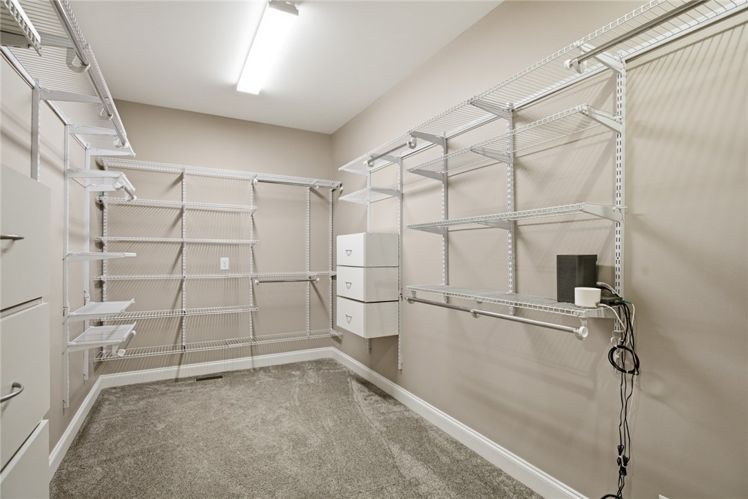 196 Flyroot Trail Pickens, SC 29671 - Photo 21 of 48 This spacious walk-in closet features ample storage with organized shelving, offering functional design.