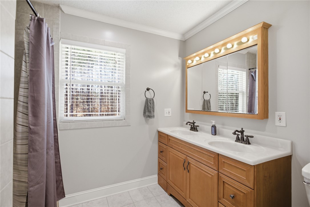 196 Flyroot Trail Pickens, SC 29671 - Photo 27 of 48 This bathroom offers practical double sinks and a functional window with privacy blinds.