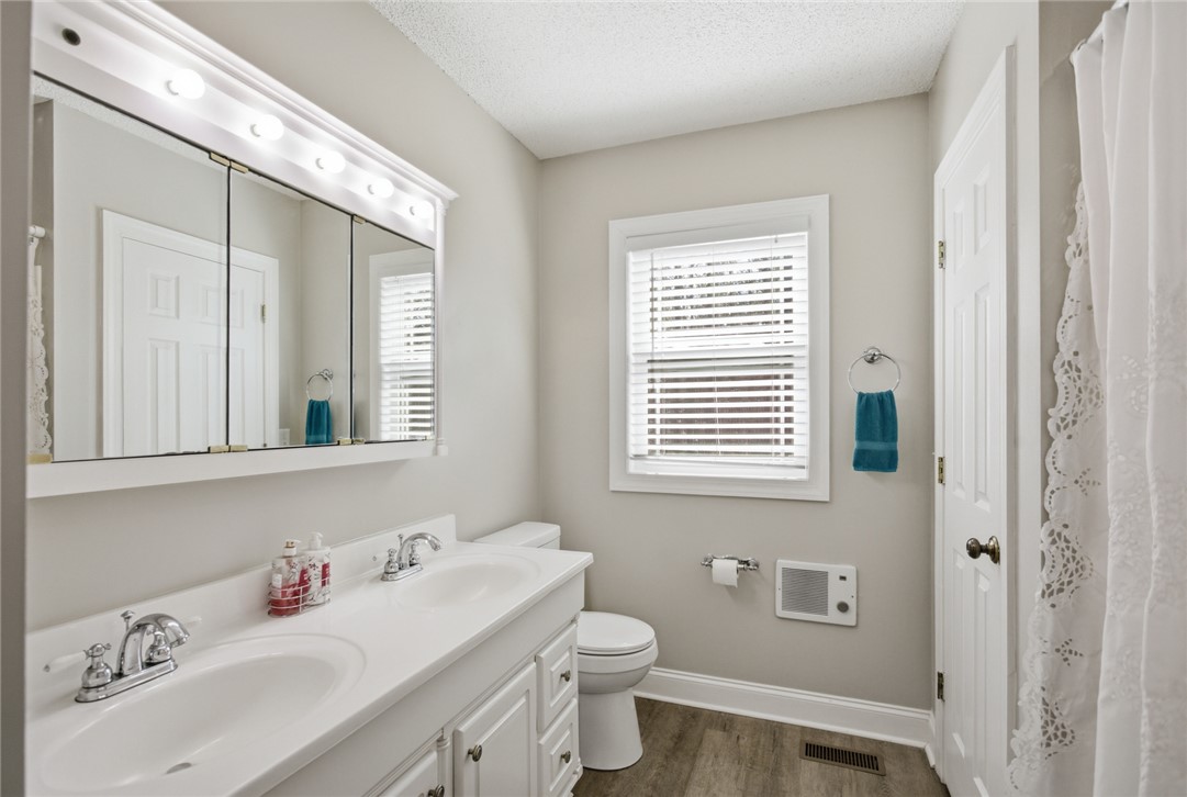 196 Flyroot Trail Pickens, SC 29671 - Photo 30 of 48 This bright bathroom offers dual sinks, a window, and a spacious vanity.