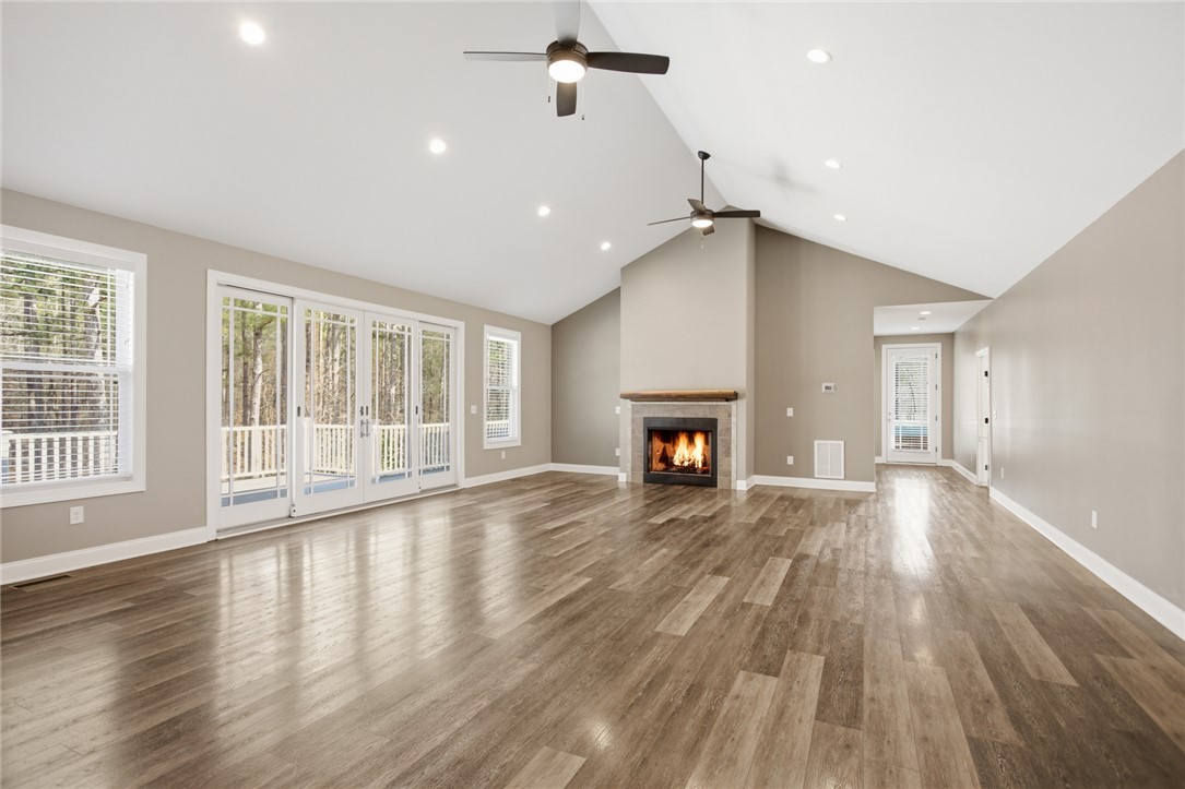 196 Flyroot Trail Pickens, SC 29671 - Photo 8 of 48 This expansive living space features vaulted ceilings, a cozy fireplace, and direct access to outdoor living.
