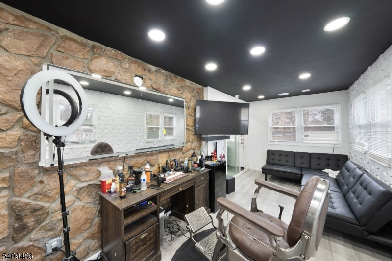 376 Elmora Avenue, Unit 378 Elizabeth, NJ 07208 - Photo 11 of 49 a living room with furniture a flat screen tv and a window