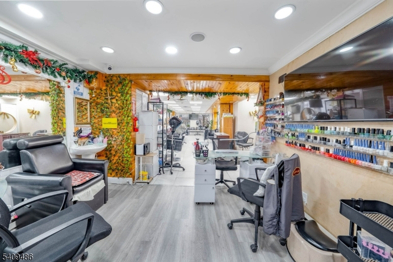 376 Elmora Avenue, Unit 378 Elizabeth, NJ 07208 - Photo 14 of 49 a room with lots of wooden furniture and a large window