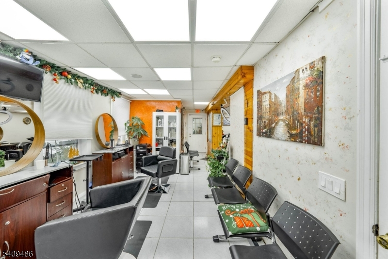 376 Elmora Avenue, Unit 378 Elizabeth, NJ 07208 - Photo 19 of 49 a living room with furniture a rug and white walls