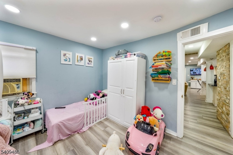 376 Elmora Avenue, Unit 378 Elizabeth, NJ 07208 - Photo 32 of 49 a bedroom with furniture and a bed