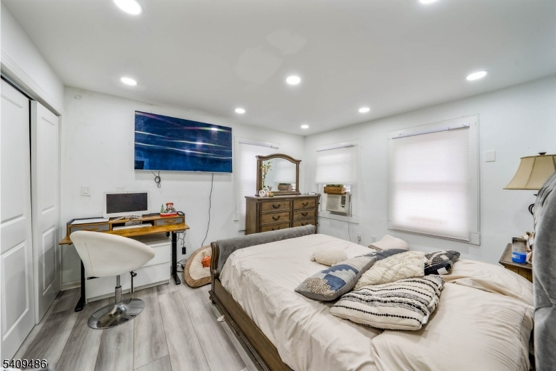 376 Elmora Avenue, Unit 378 Elizabeth, NJ 07208 - Photo 35 of 49 a bedroom with a bed and a wooden floor