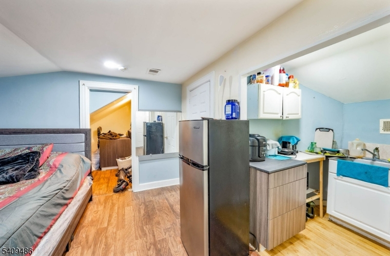 376 Elmora Avenue, Unit 378 Elizabeth, NJ 07208 - Photo 40 of 49 a view of a kitchen with fridge and workspace
