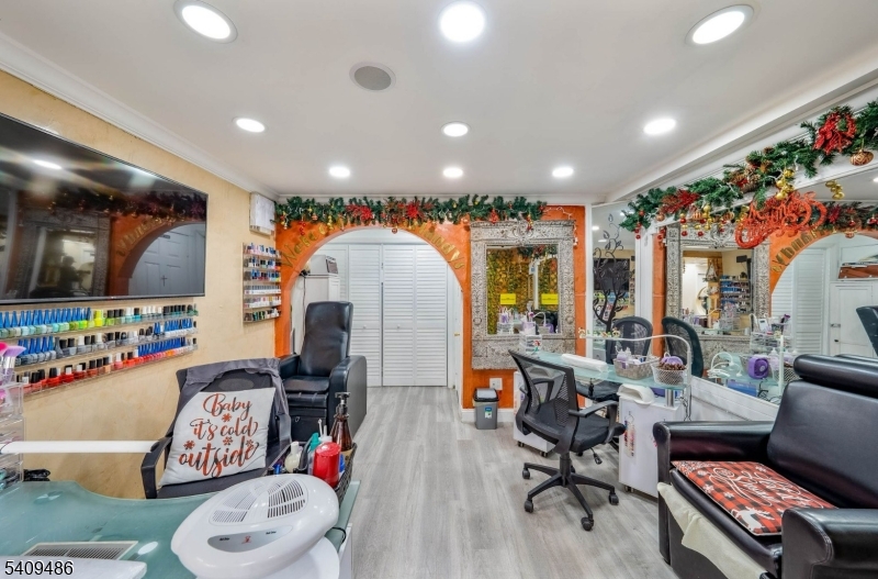 376 Elmora Avenue, Unit 378 Elizabeth, NJ 07208 - Photo 8 of 49 a living room with furniture and a flat screen tv