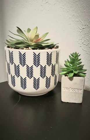 a close up of a vase of flowers on a table