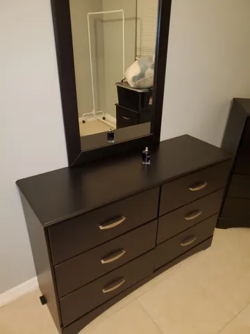 a view of closet with mirror