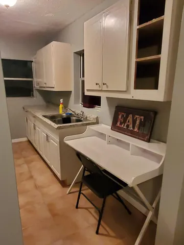 a kitchen with a stove a sink and a refrigerator