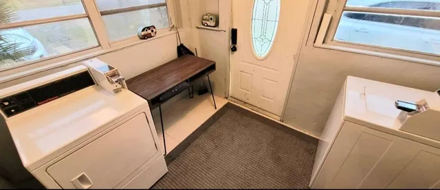 a view of a kitchen with sink and refrigerator