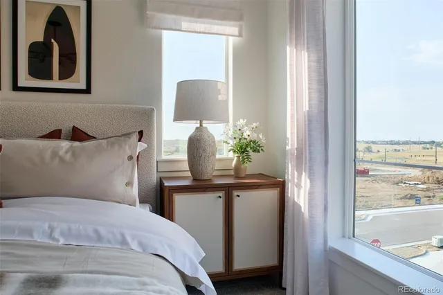 a bedroom with a bed and painting on the wall