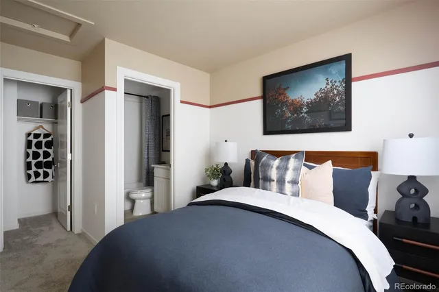 a bedroom with bed and wall painting