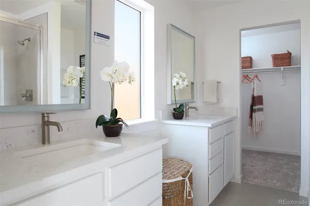 a bathroom with a double vanity sink and a mirror