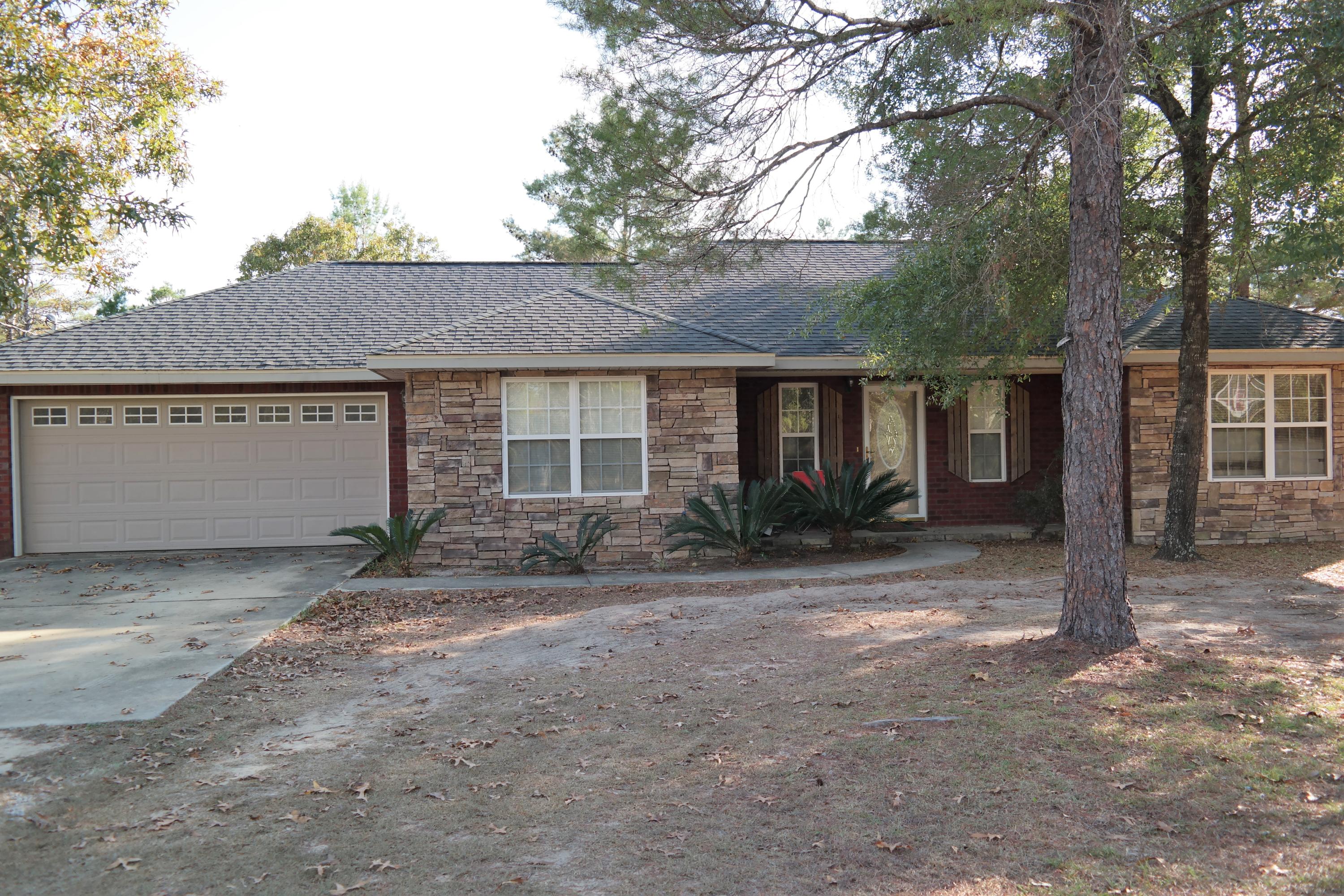 130 Crocus Avenue DeFuniak Springs, FL 32433 - Photo 1 of 24 a view of a house with a yard and large tree